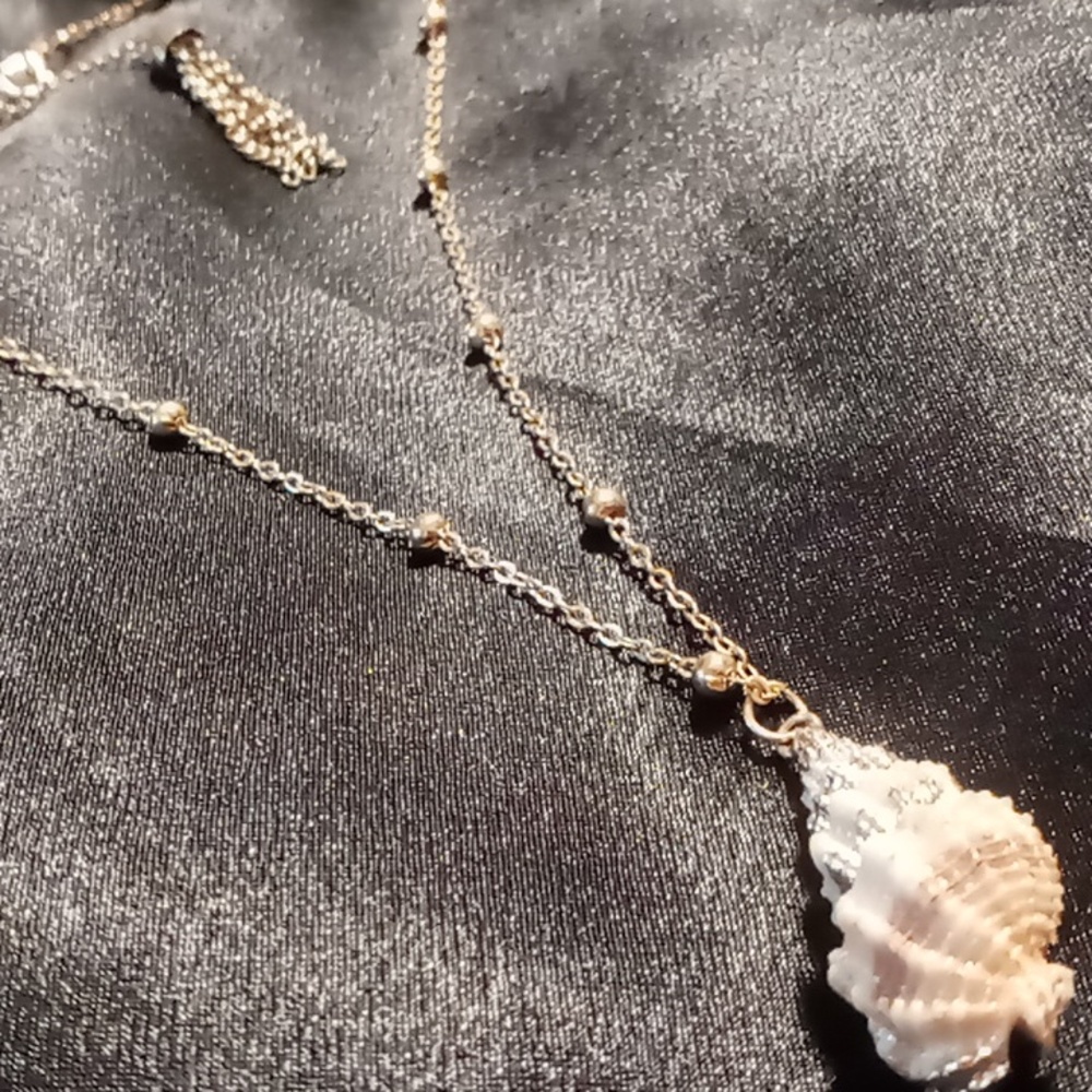 Shell necklace on gold tone beaded chain